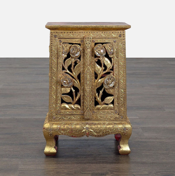 Hand-carved and gilded cabinet from Baan Tawai village, showcasing traditional Thai craftsmanship, made in 2005.  