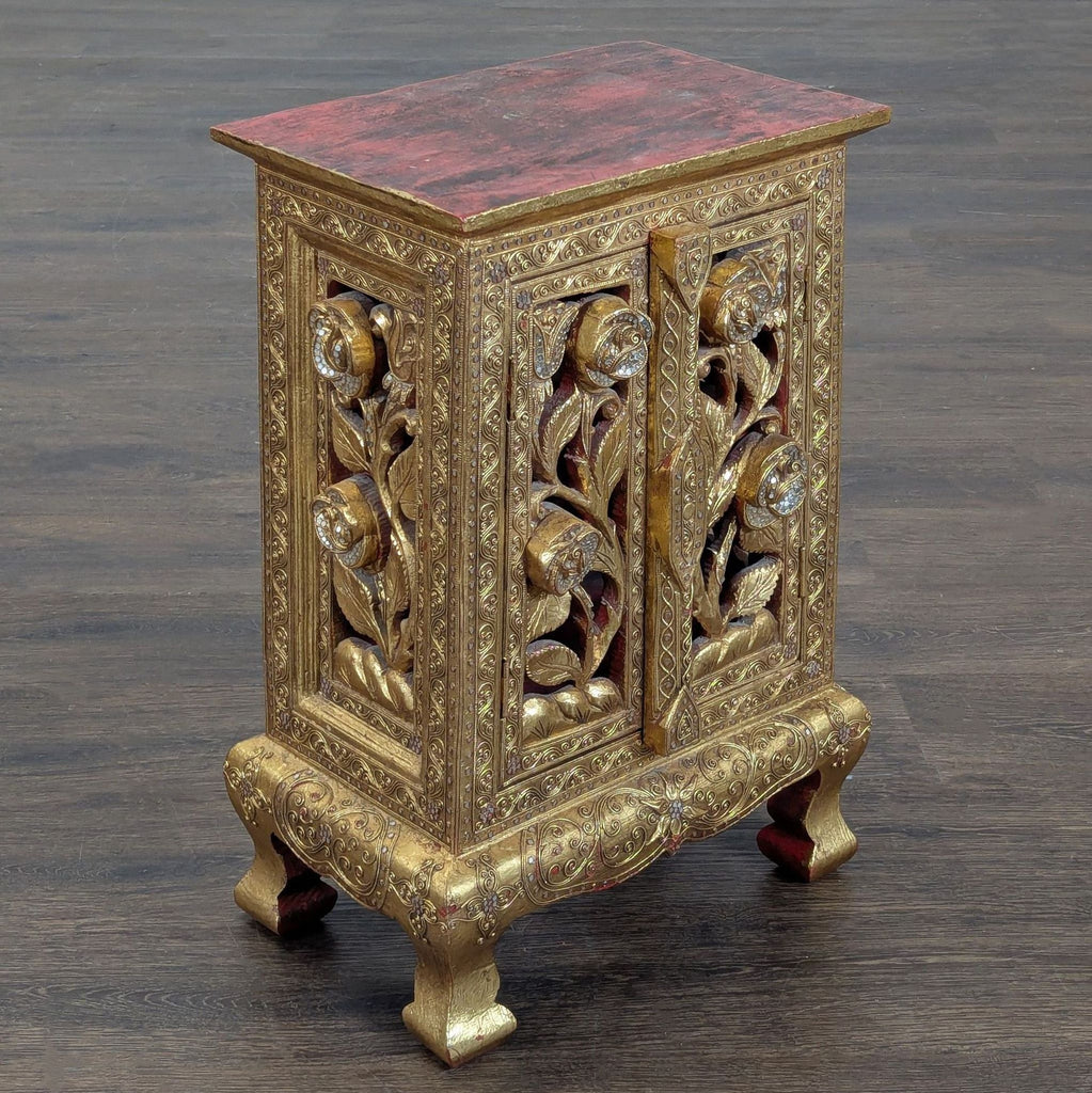 Thai handicraft cabinet, richly decorated with elaborate carving and gilding, produced in Baan Tawai in 2005.