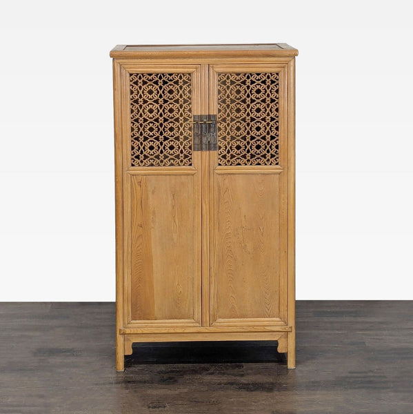 Illuminated cabinet with interior shelves, carved top door panels, and a locking pin.