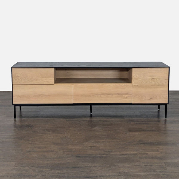 Sleek black and wood media console with drawers, cabinets, open shelf, and metal legs for entertainment storage.