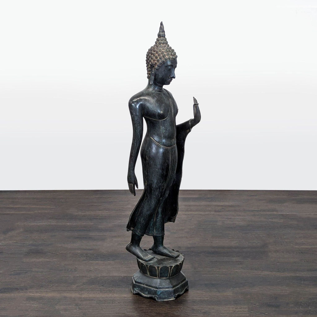 Finely crafted bronze Buddha statue, showcasing intricate textures and a serene expression on a decorative pedestal.