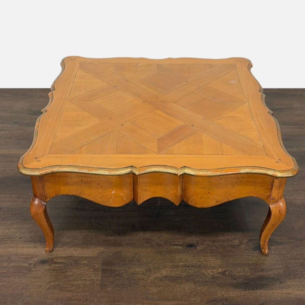 Traditional coffee table showcasing a patterned wood surface, curved legs, and concealed storage.