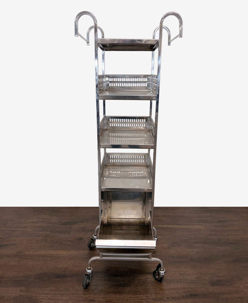Stainless steel utility cart with four shelves and wheels, ideal for organizing kitchen supplies.