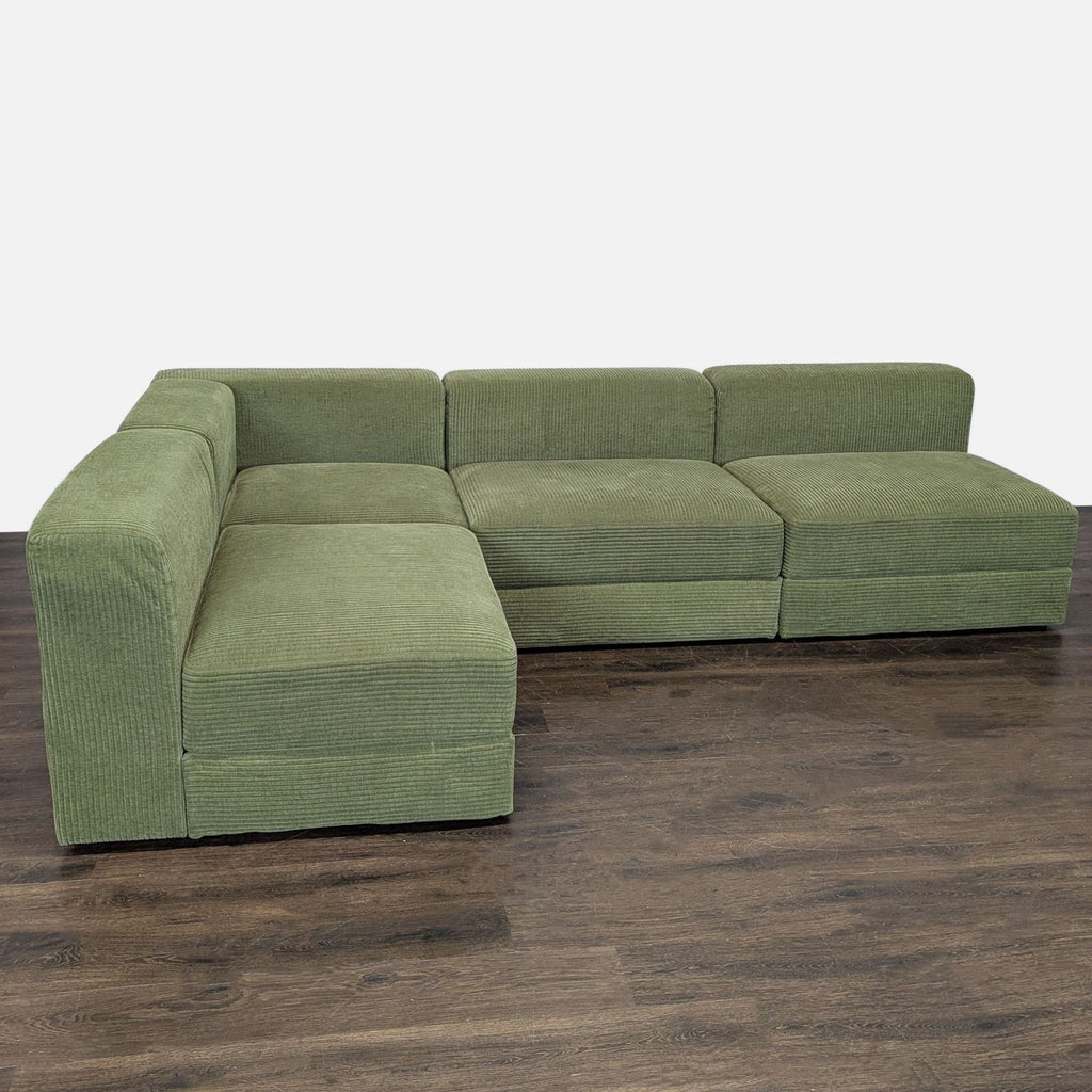Green corduroy Ikea sectional with hidden storage under each seat, L-shaped for spacious and stylish seating.