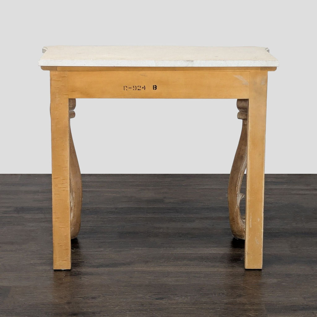 Elegant side table with a stone top, ornate carved base, and curved legs ending in paw-shaped feet.