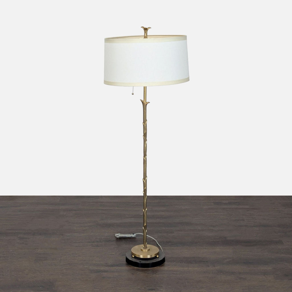 Brass floor lamp with marble base and white drum shade, ideal for cozy living spaces or bedrooms.  
