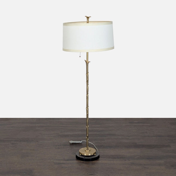 Brass floor lamp with marble base and white drum shade, ideal for cozy living spaces or bedrooms.  