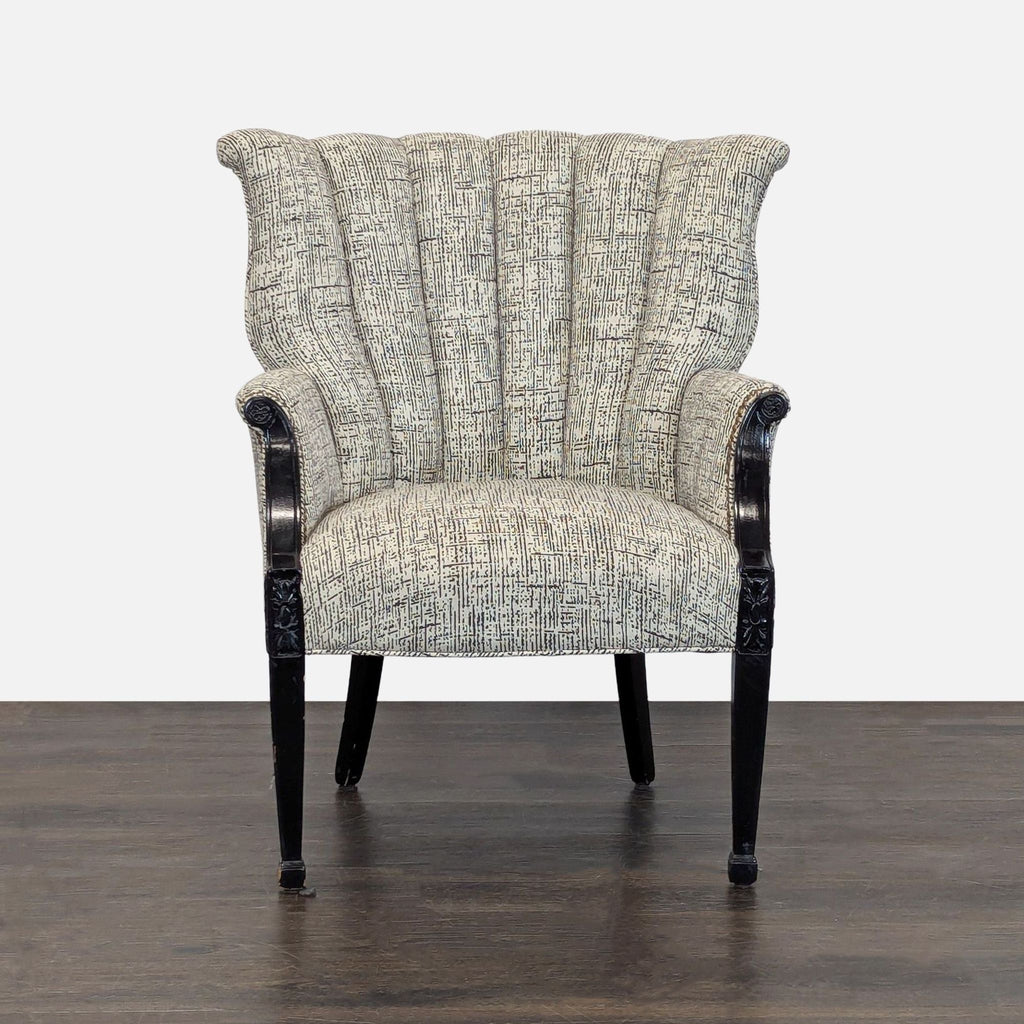A modern lounge chair with textured fabric, fluted backrest, and black carved wooden arms and legs.