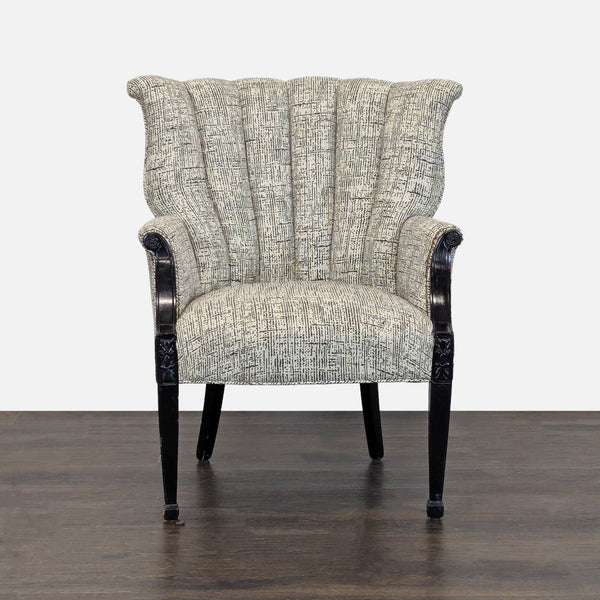 A modern lounge chair with textured fabric, fluted backrest, and black carved wooden arms and legs.
