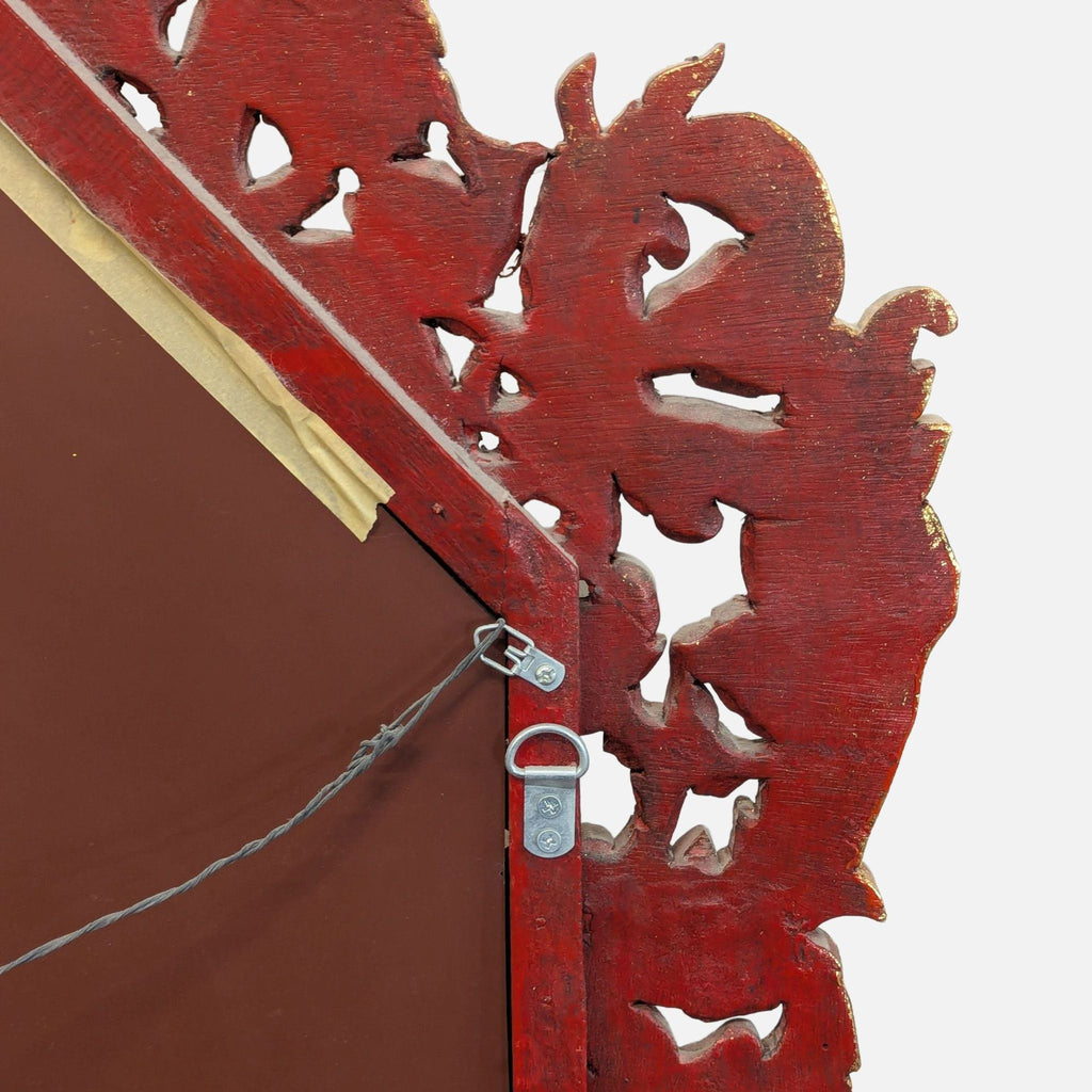 Decorative mirror made of hand-carved, gilded teak from Baan Tawai, Chiang Mai, dating to 2005.