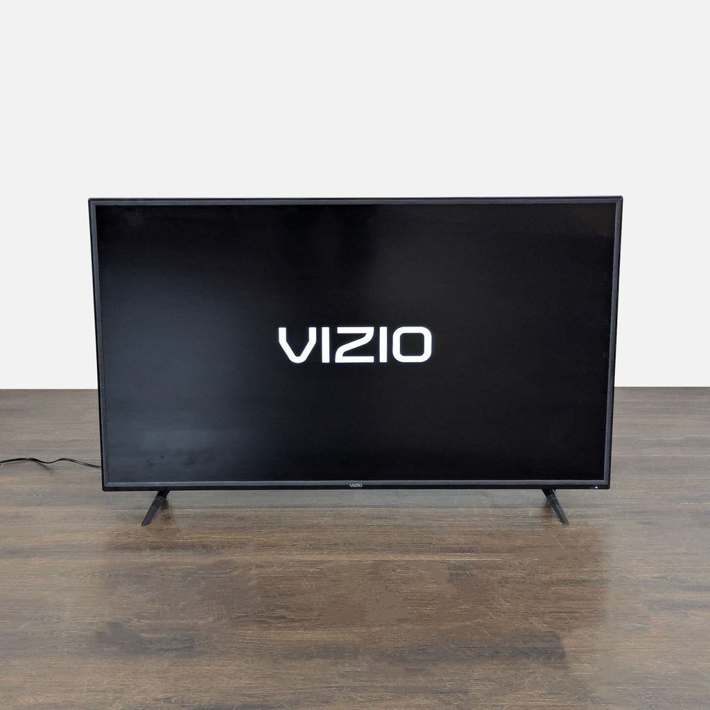 Vizio TV, 55-inch LED model, showing logo on screen, suitable for watching movies, shows, and games.  