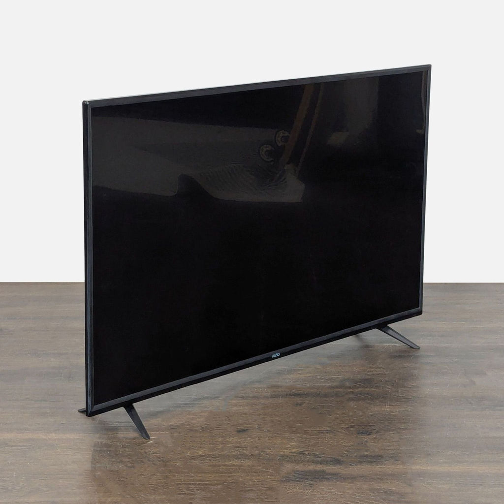Large Vizio flat-screen TV in good condition, features clear picture and modern design for any room.