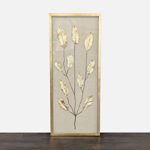 Gold metallic leaf wall art by Uttermost on natural fabric, framed in gold and ready to hang.