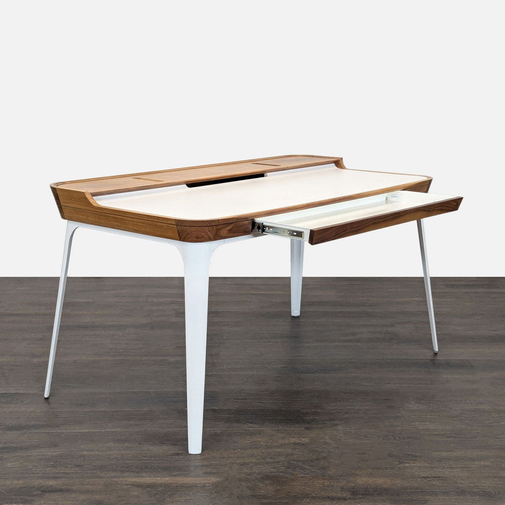 1. Modern Herman Miller desk with a sleek surface and minimalist metal legs, ideal for home or office use.