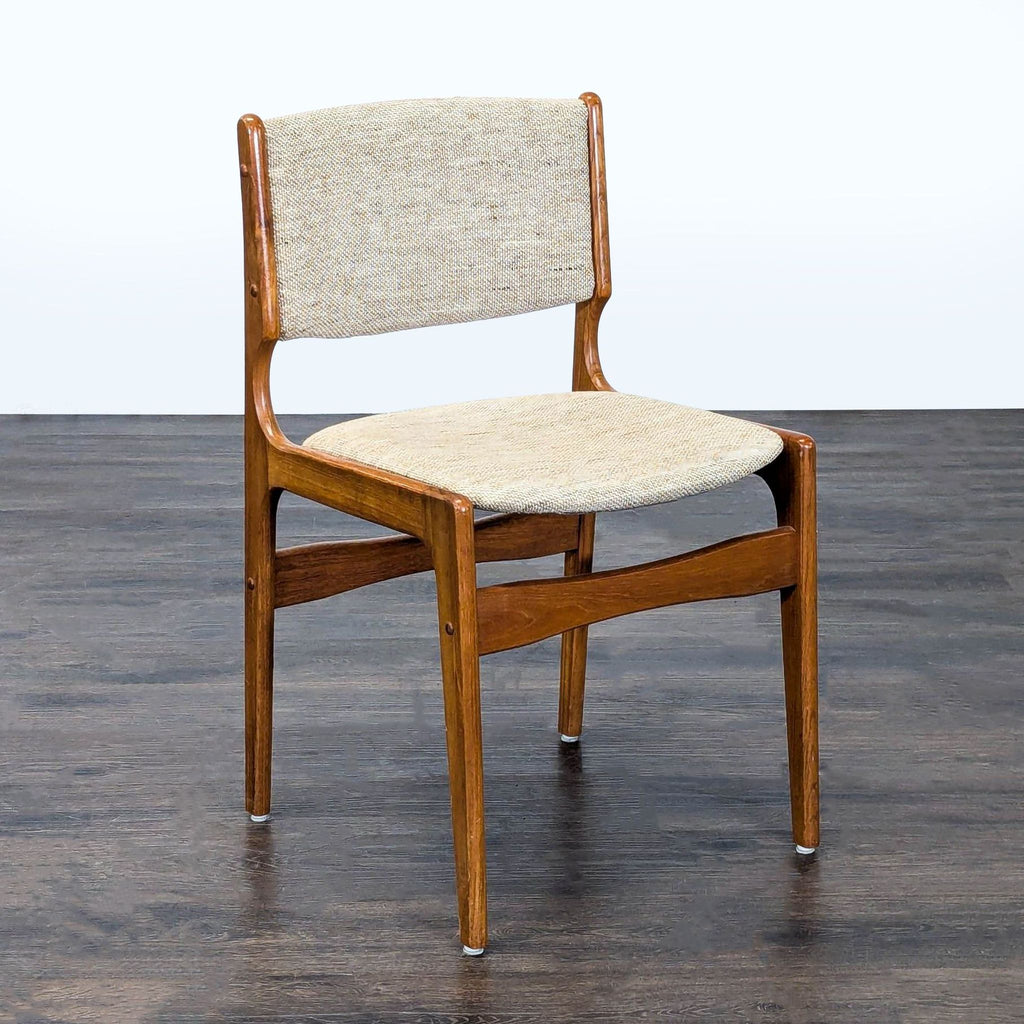 2. Elegant dining chair featuring a fabric-upholstered seat and curved wooden legs.