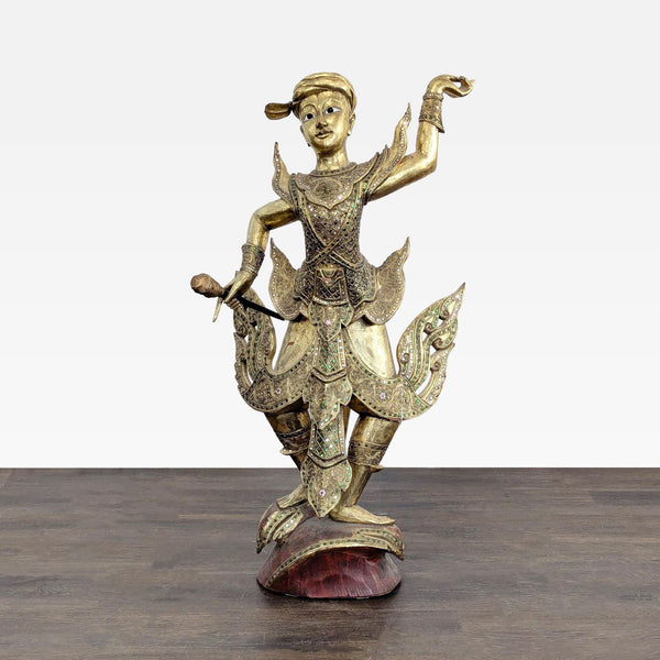 Hand-carved teak Thai dancer sculpture with gilt finish and colorful glass inlay on red base.