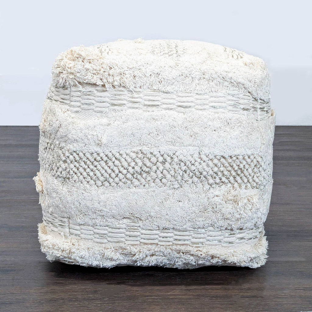 Round, boho chic ottoman by TOV, featuring cotton material and a cozy, textured surface.  