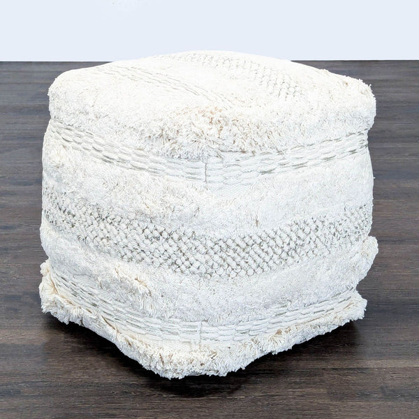 Handwoven cotton pouf with a soft textured finish, perfect for boho-inspired decor, from TOV.  
