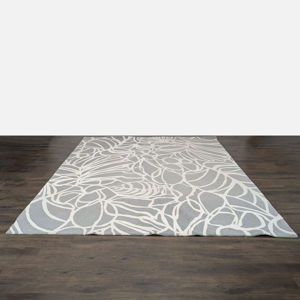 1. Modern West Elm rug with geometric patterns, suitable for contemporary living spaces.  