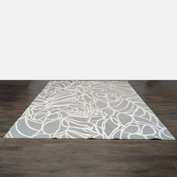 1. Modern West Elm rug with geometric patterns, suitable for contemporary living spaces.  