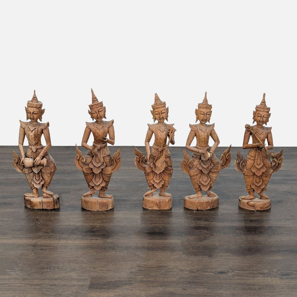 Set of five hand-carved teak sculptures from Thailand showing detailed celestial musicians and dancers.