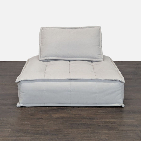 Restoration Hardware lounge chair with deep seat and plush cushions, in light fabric, perfect for relaxing spaces.