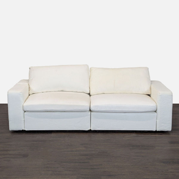7th Avenue Loveseat in soft white fabric featuring wide armrests and plush cushions, ideal for small spaces.