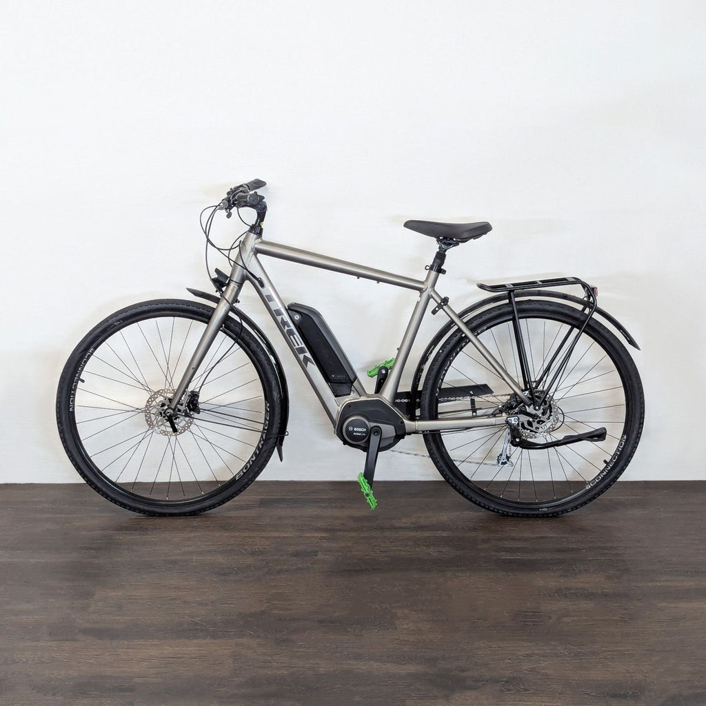 Trek electric hybrid bike with Bosch motor, fenders, rear rack, and disc brakes, ideal for commuting and recreation.  