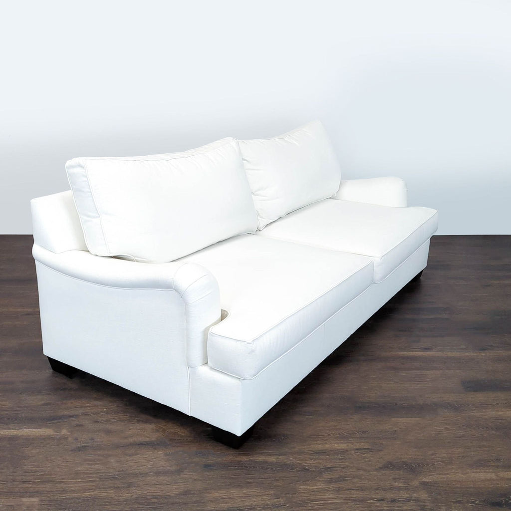 1. Pottery Barn 3-seat sofa in a modern living room, featuring plush cushions and neutral upholstery.