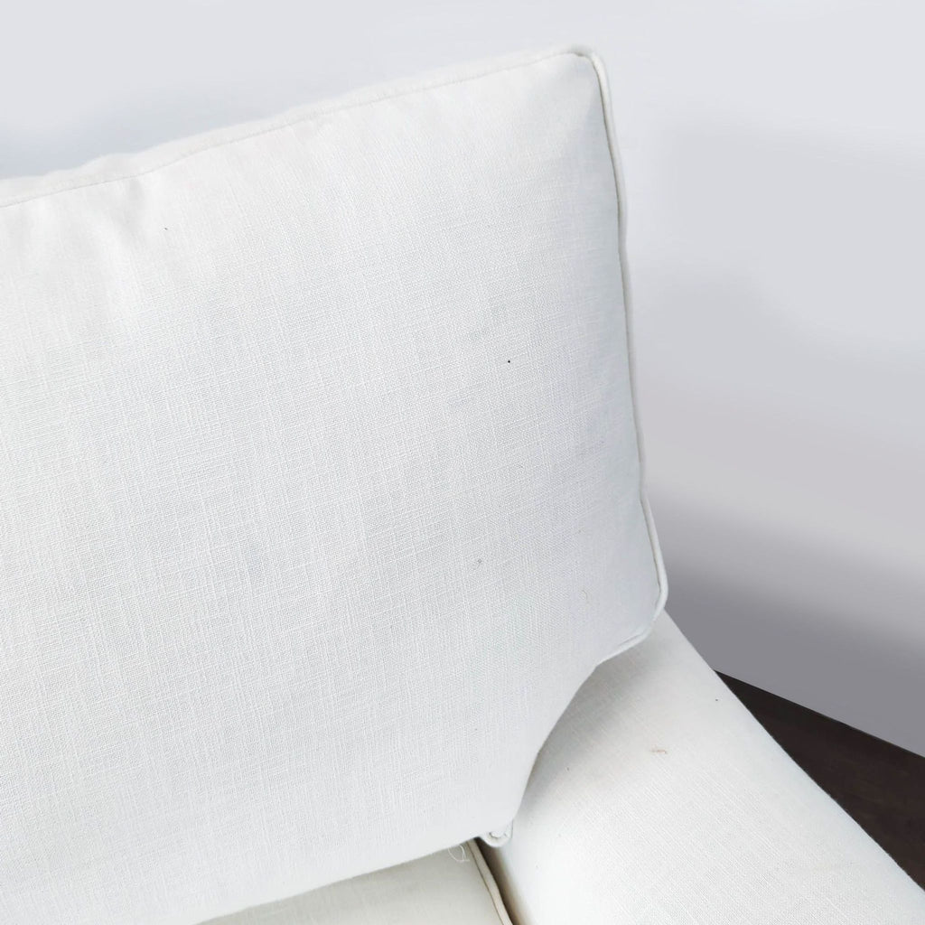 2. Spacious Pottery Barn three-seater couch displayed with decorative pillows and sleek wood legs.