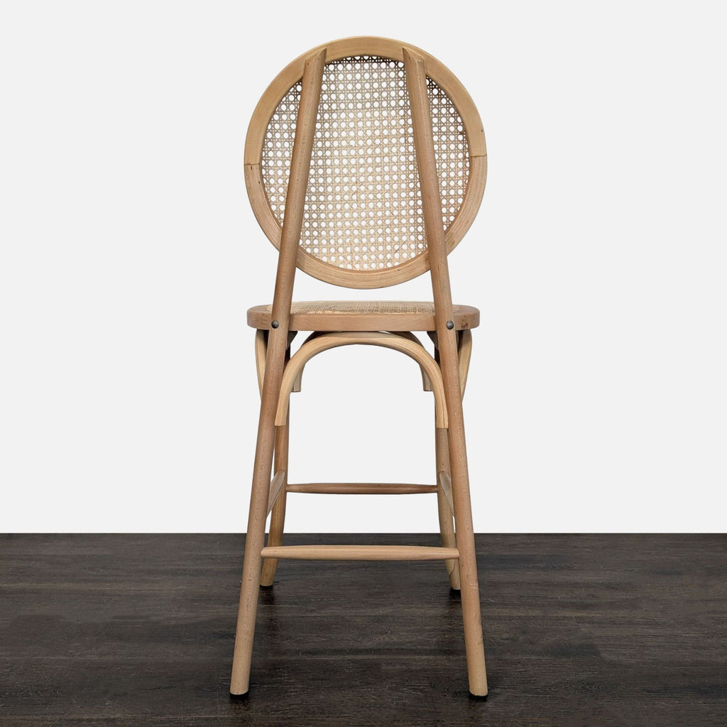 Rattan stool with a bentwood structure, cane-patterned back, woven seat, and sturdy footrest support.