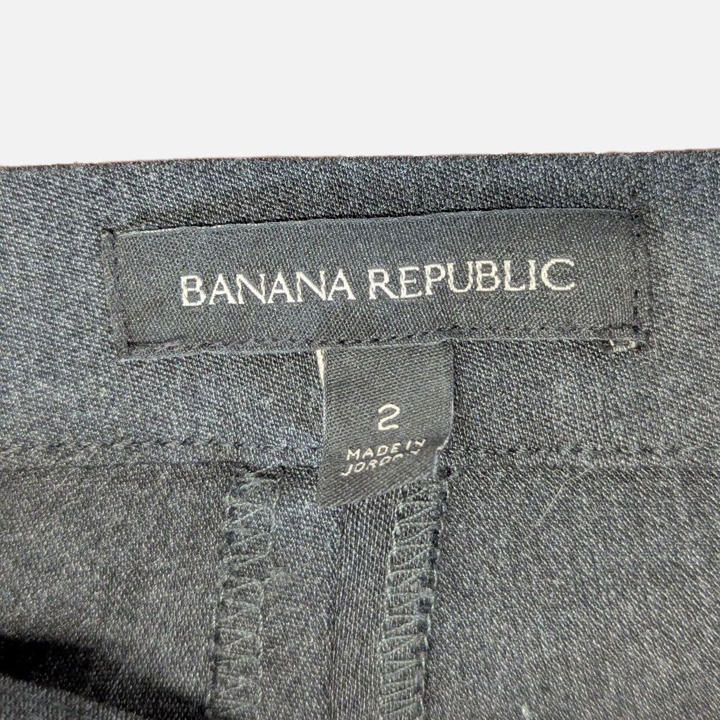 Close-up of Banana Republic women's pants label showing size 2 and "Made in Jordan" text on black fabric.  