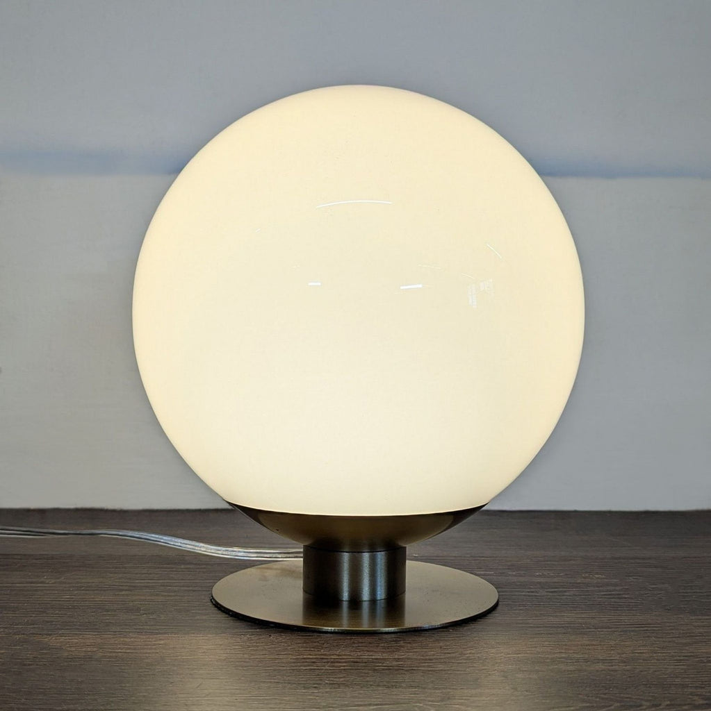 Modern table lamp from West Elm with a white globe shade and brass base, ideal for cozy lighting.