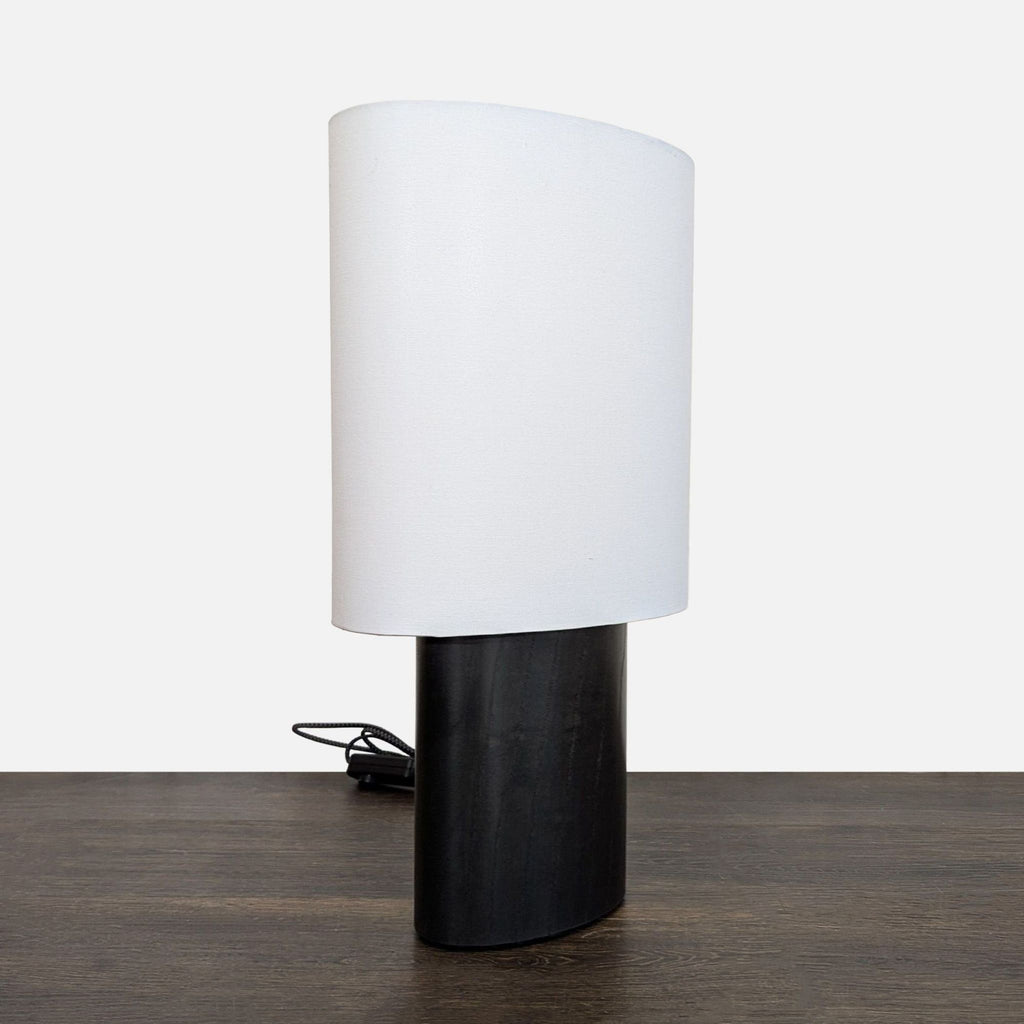 Modern black oak table lamp with white fabric shade, ideal for bedrooms or offices, by Room & Board.