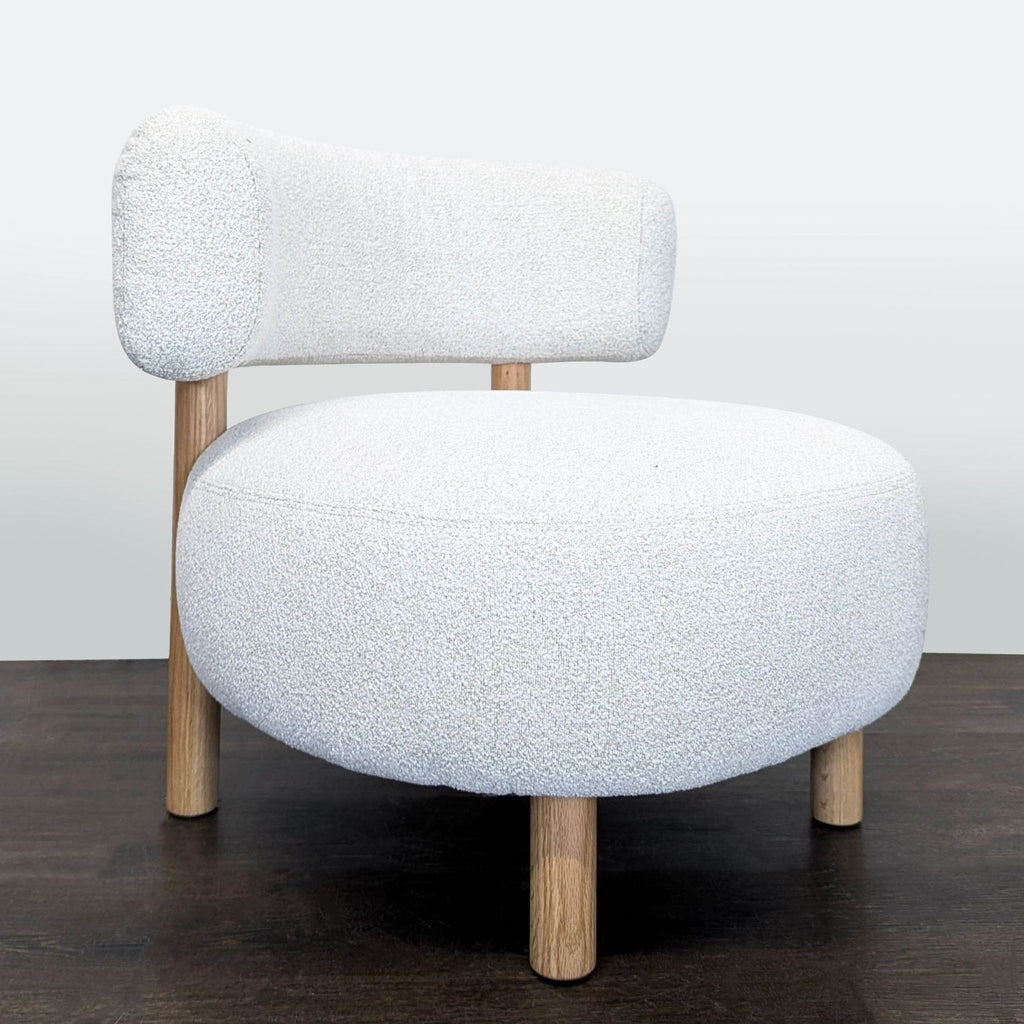 2. Comfortable Ikea lounge chair with soft white bouclé fabric and sturdy wooden legs, perfect for any space.  