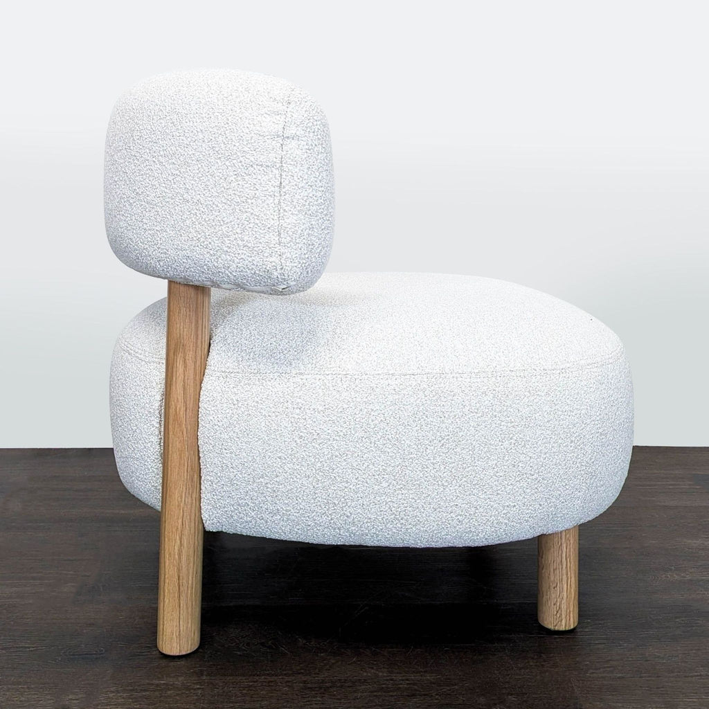 3. Stylish Ikea chair featuring a curved backrest, wide seat, and trendy bouclé fabric for modern interiors.