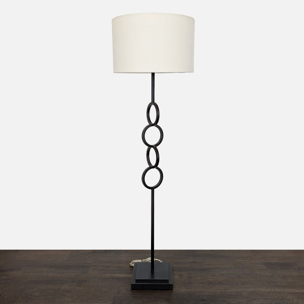 Modern Black Floor Lamp with White Drum Shade and Linked Ring Design