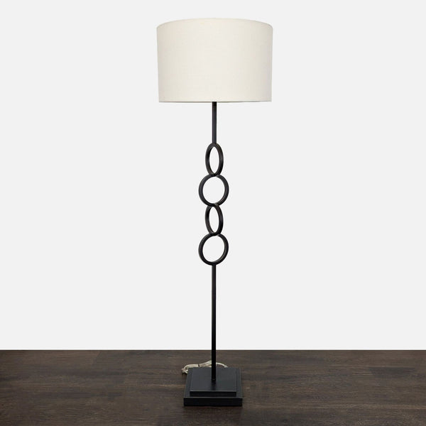 Modern Black Floor Lamp with White Drum Shade and Linked Ring Design