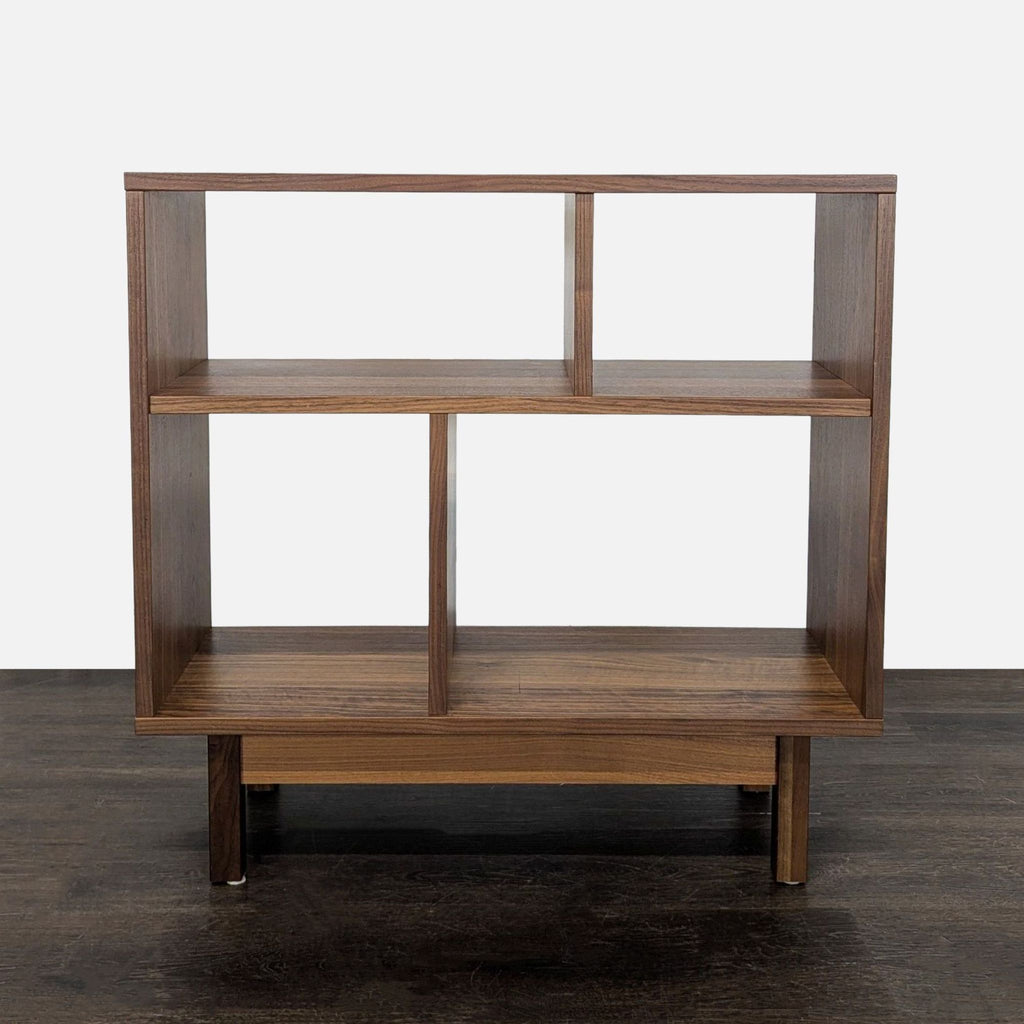 Room & Board wooden bookshelf with open shelves, modern design, and varied spaces for books or decor.  