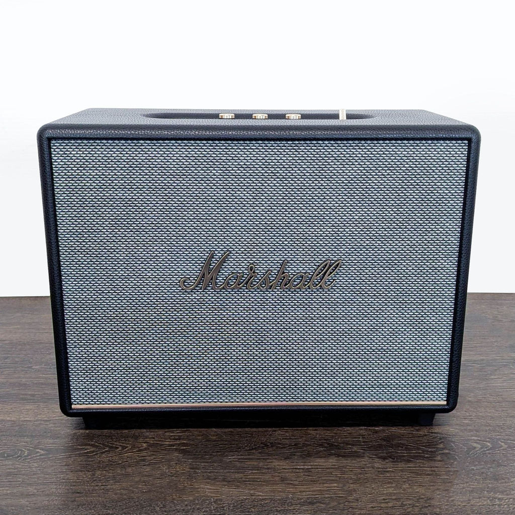 1. Marshall audio equipment featuring a classic black and gold design with prominent brand logo on the front.