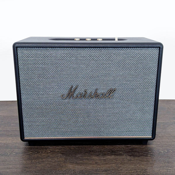 1. Marshall audio equipment featuring a classic black and gold design with prominent brand logo on the front.