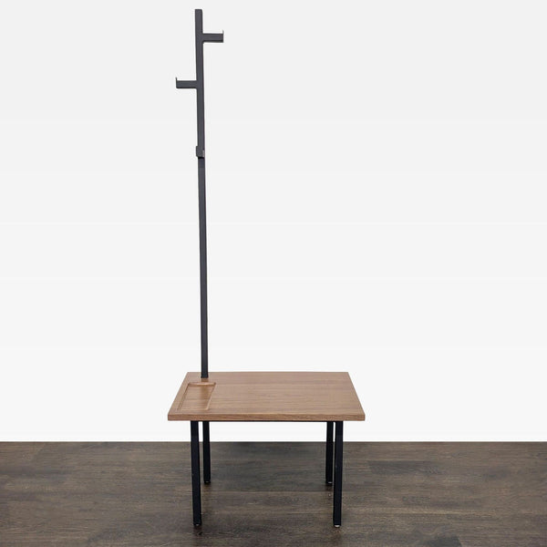Modern bench coat rack by Room & Board with wood seat, metal legs, and hooks for entryway storage.
