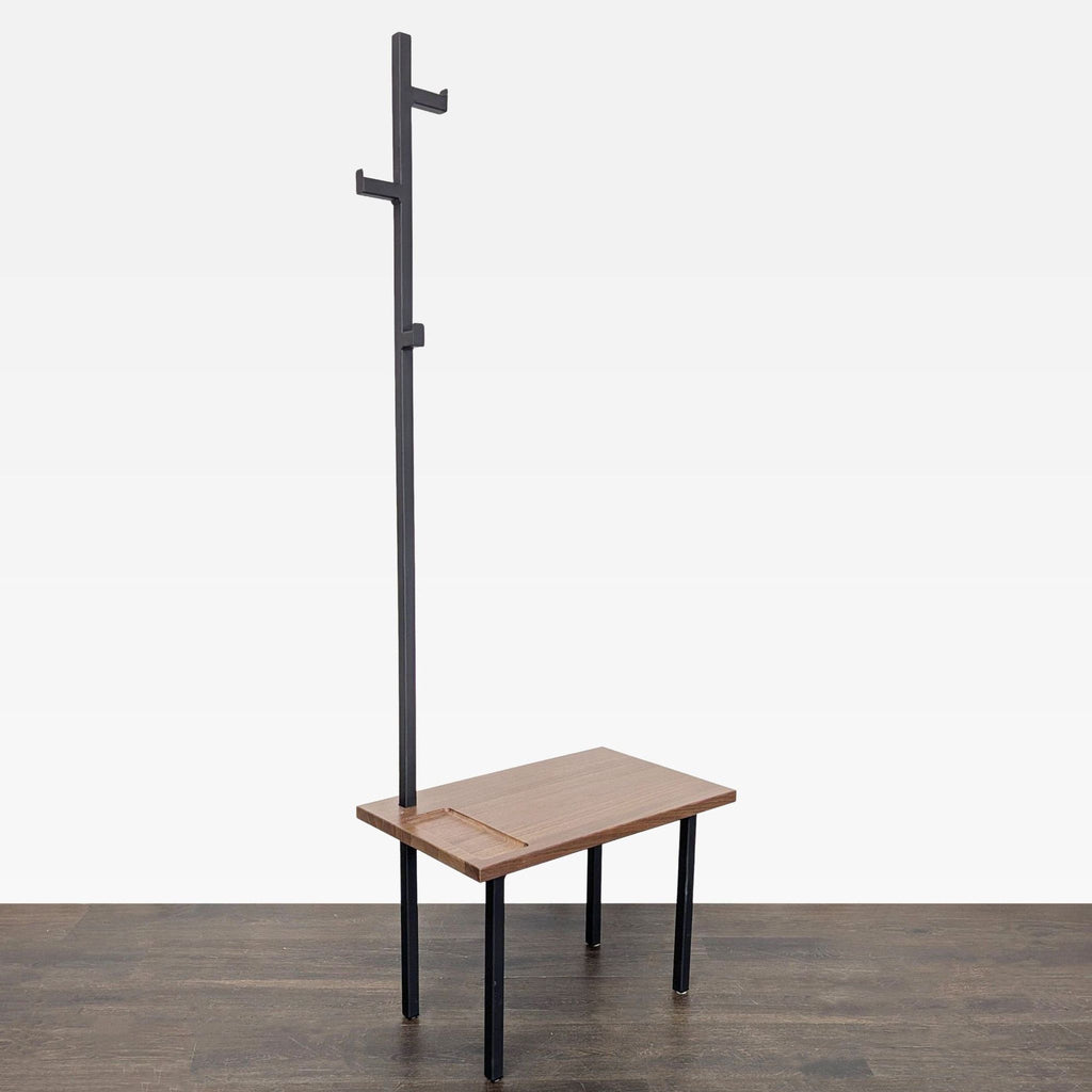 Sleek Room & Board coat rack bench combining wood surface, metal base, and integrated hanging hooks.