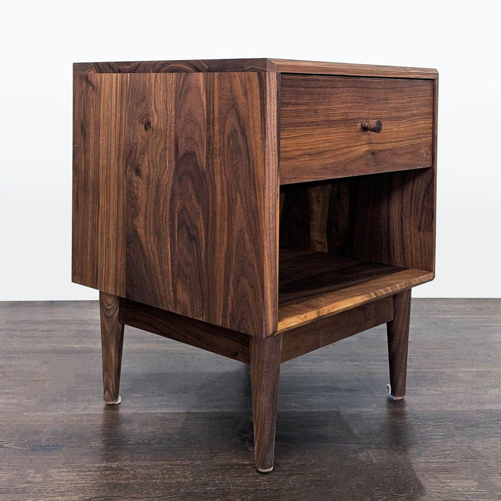 1. Modern Room & Board end table with minimalist lines and a natural wood finish, shown in a living room.