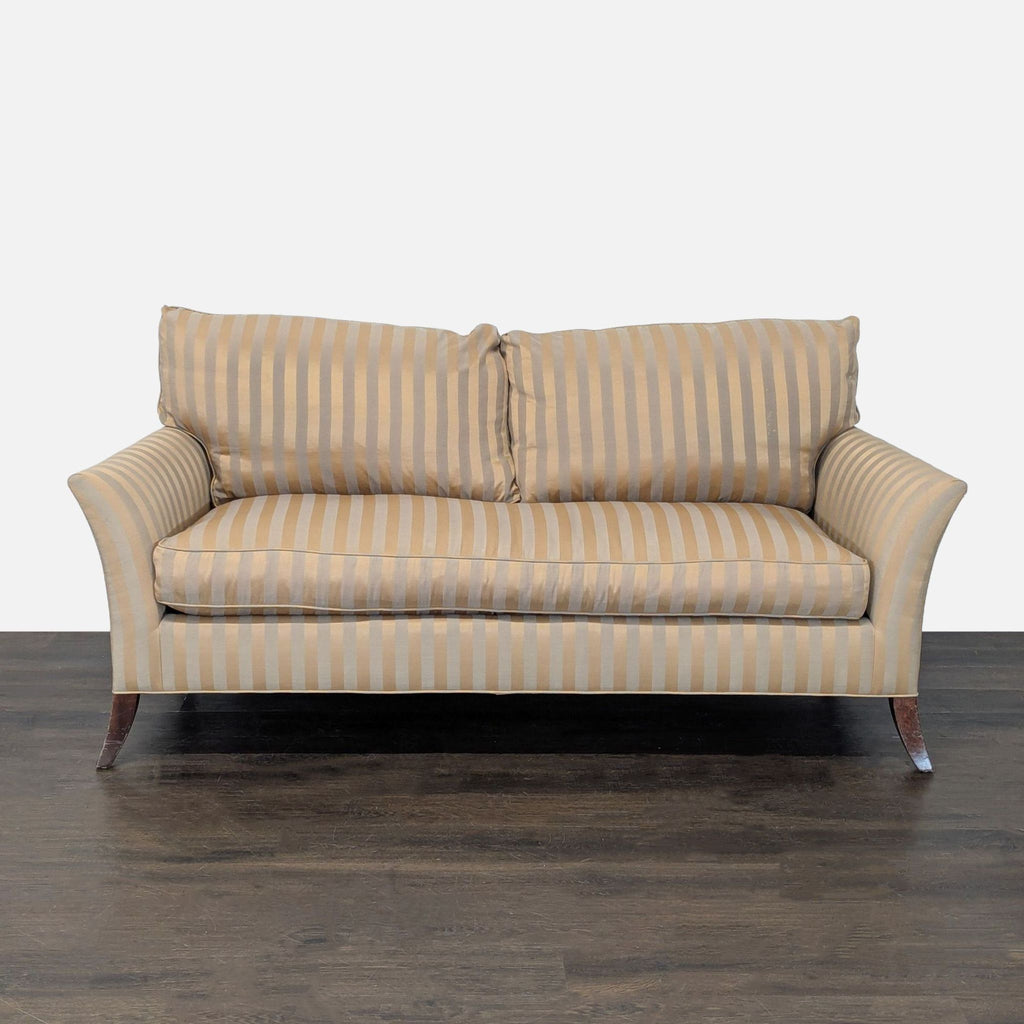 3-seat sofa in beige and gold stripes, plush cushions, curved arms, and wooden legs.
