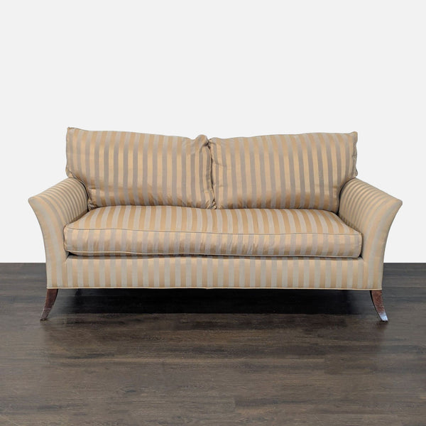 3-seat sofa in beige and gold stripes, plush cushions, curved arms, and wooden legs.