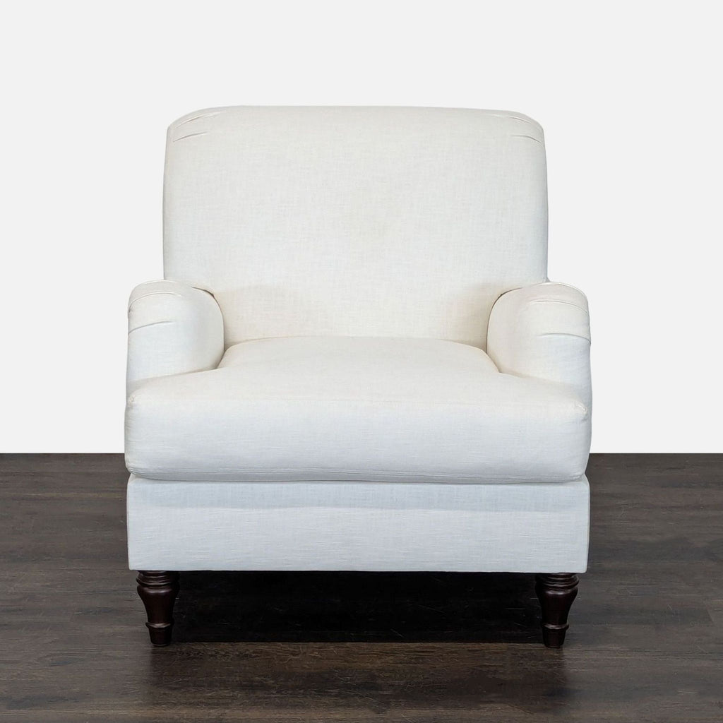 White Pottery Barn lounge chair with wooden legs, cushioned seat and back, perfect for living spaces.