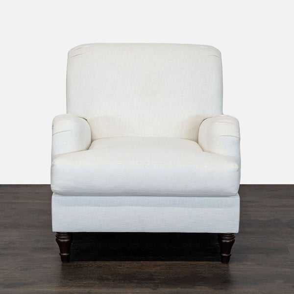 White Pottery Barn lounge chair with wooden legs, cushioned seat and back, perfect for living spaces.