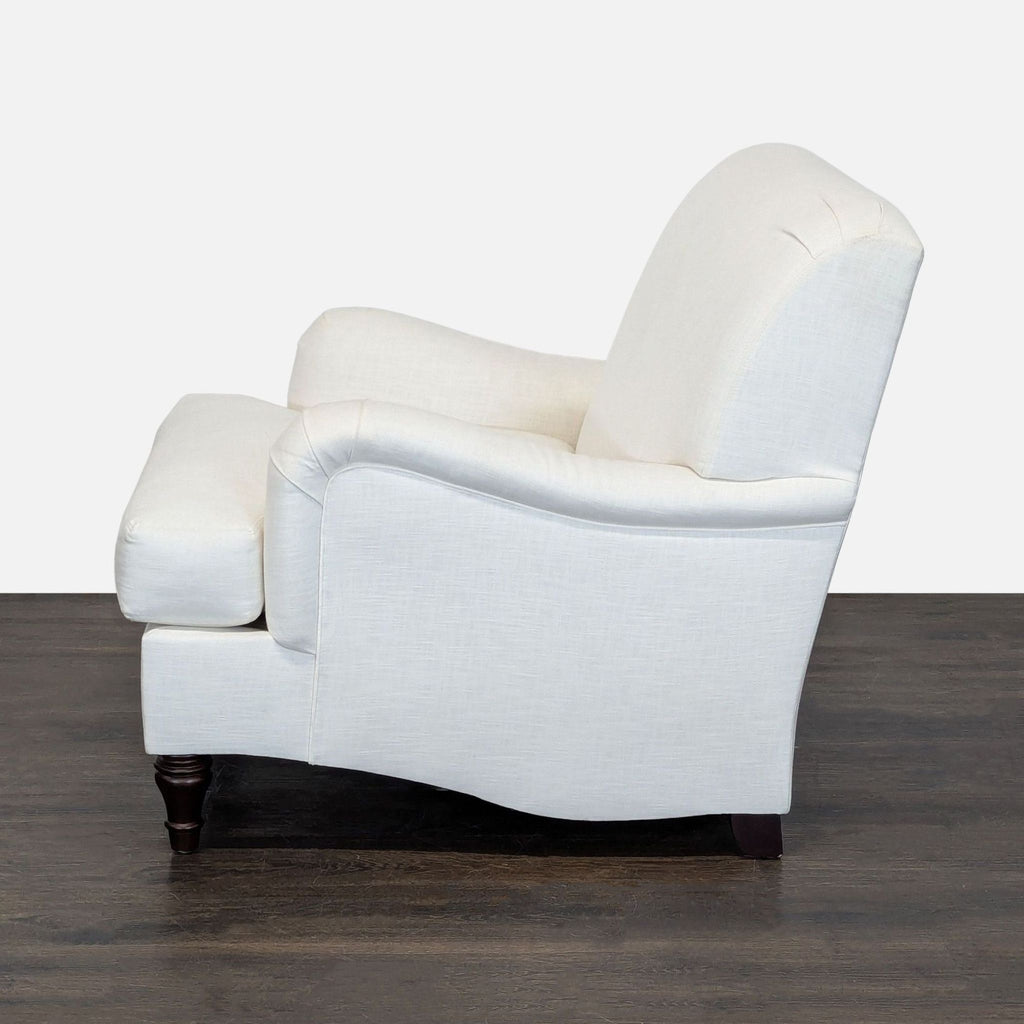Modern lounge chair by Pottery Barn, neutral white fabric with classic wood legs, ideal for cozy relaxation.