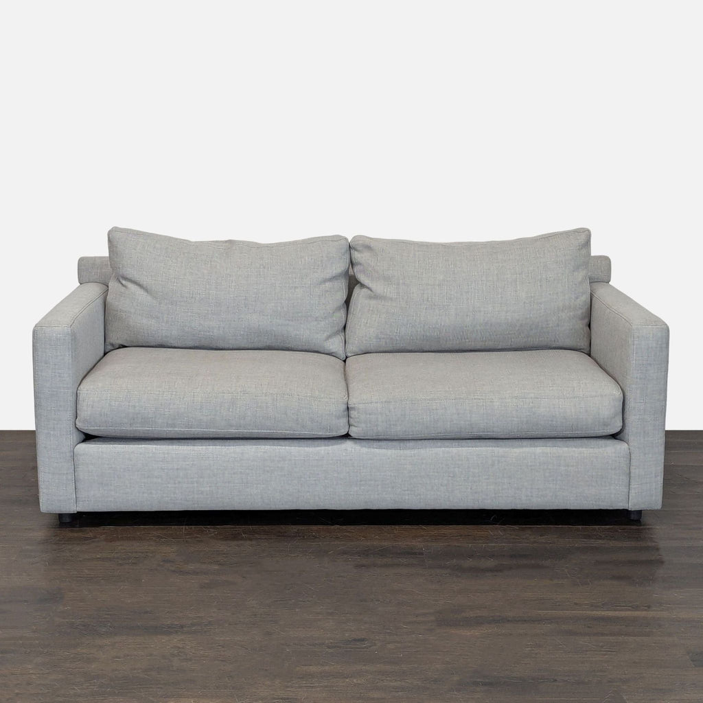 Crate & Barrel loveseat with light gray fabric upholstery, modern straight arms, and plush cushions for two.